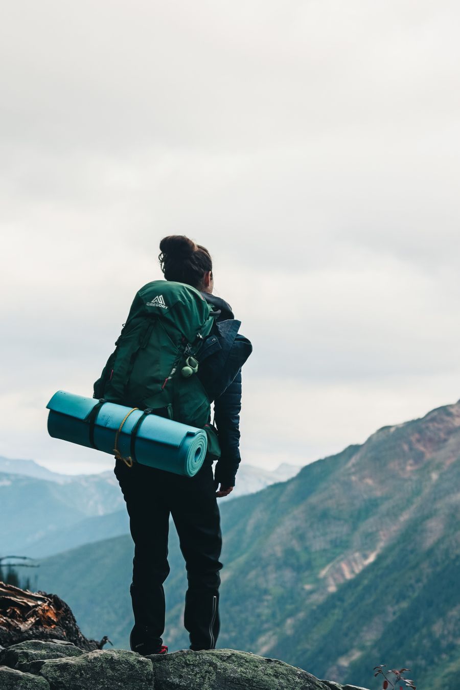 a backpacker looking at the scenery while standing on the edge of a mountain — Developers · Estonia: Coast roads and country lanes — the map keeps up wherever you roam.