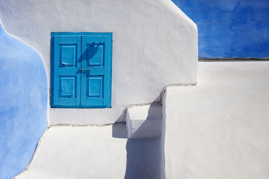a blue wooden door on a white concrete wall — Developers · Saint Lucia: One curl call provisions a Saint Lucia eSIM — 200 OK in milliseconds.