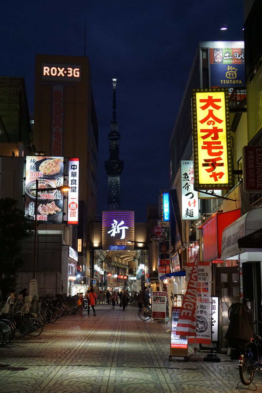 illuminated city street with neon and streetlights — Developers · Saudi Arabia: Duty-free browsing: price-checked against home before buying.