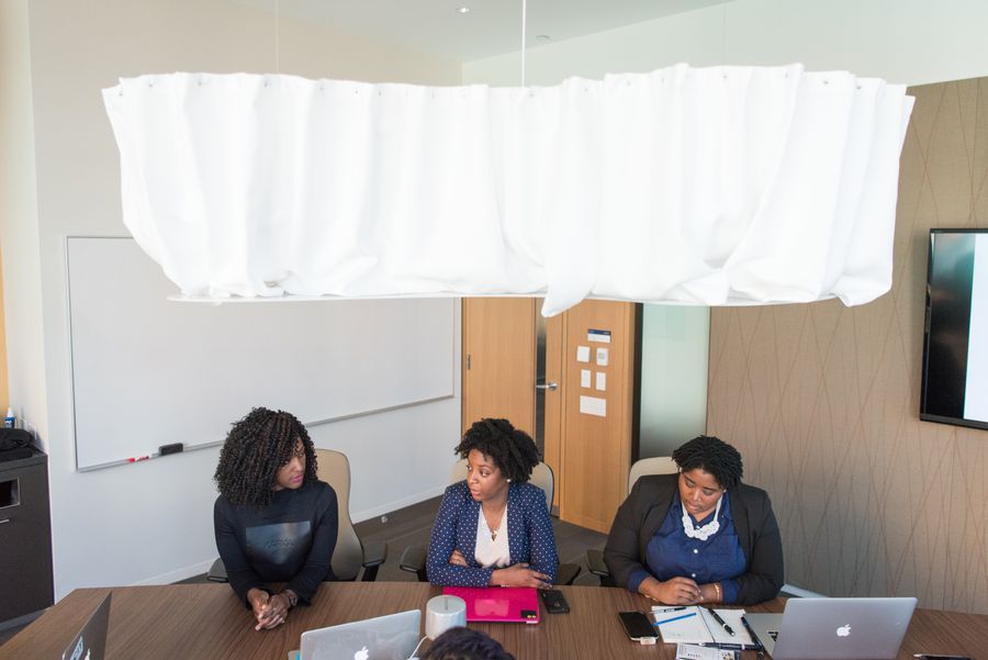 three women wearing formal clothes sitting in front of conference table — Developers: Lost in the medina, found by GPS: the blue dot never lies.