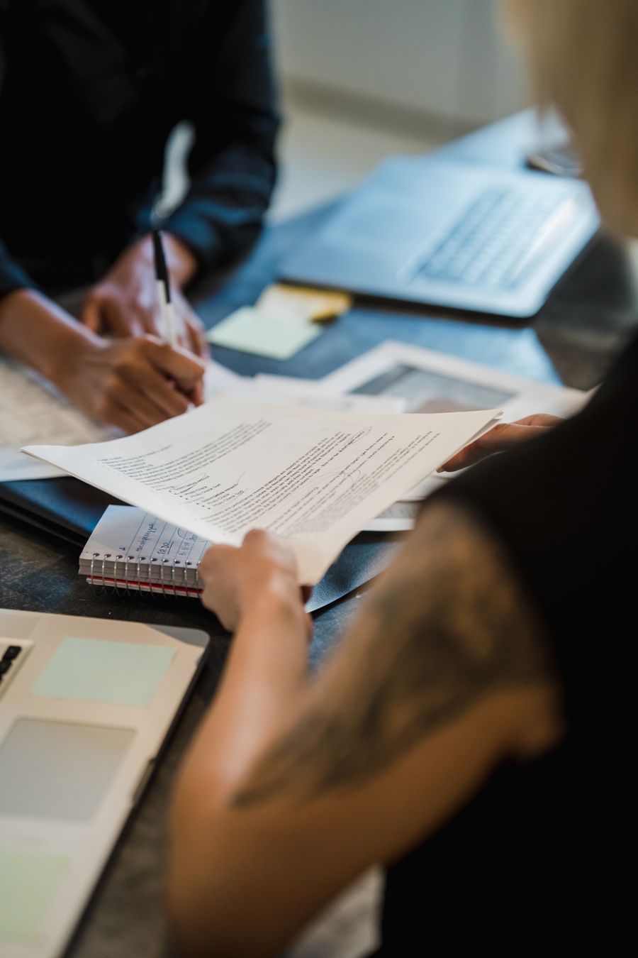 close up of women in an office signing documents — Developers · Belgium: From departure lounge to arrival hall, the data never drops.