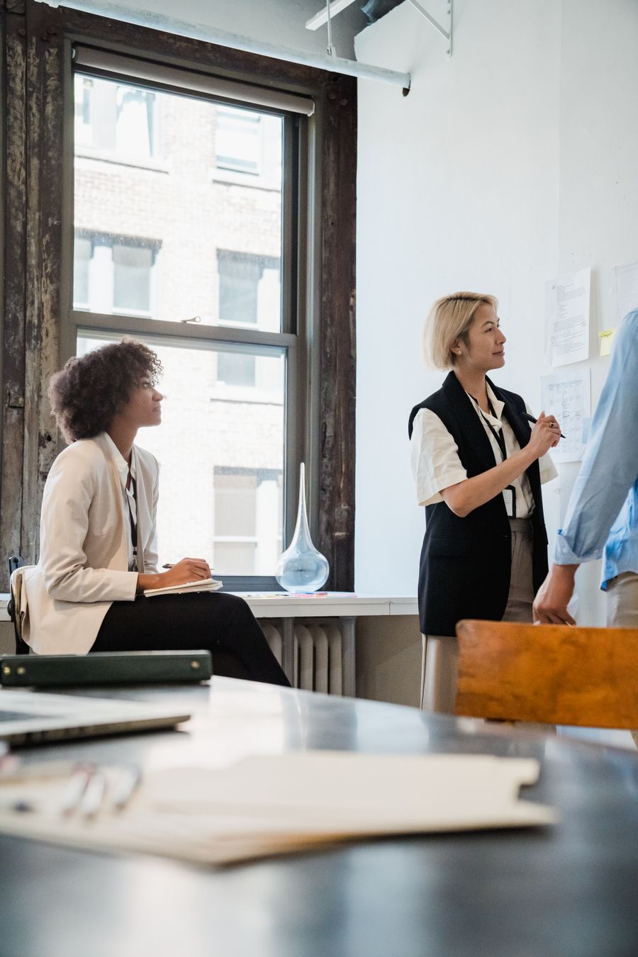employees cooperating in office — Support: Contact a human when the agent can't — escalation is one tap.