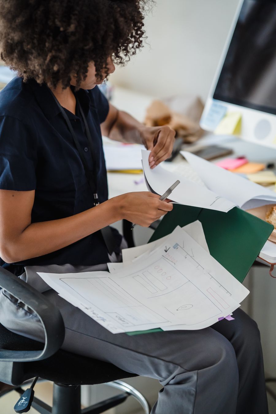woman working with documents in office — Developers · Palestine: Sunrise hikes start with a weather check — data on, boots on.