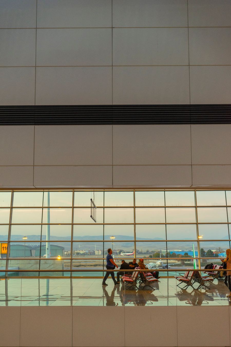 people at an airport — Developers · the Philippines: Rooftop check-in: boarding passes and hotel keys, all on the phone.