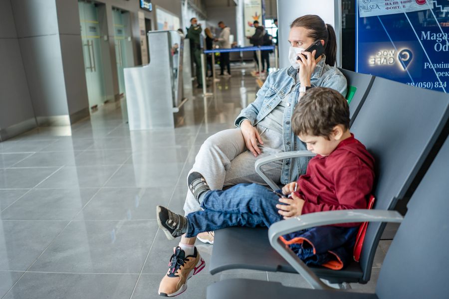mother and son waiting at the airport — Developers · Moldova: The connected trip: maps, messages and translation, all on one eSIM.