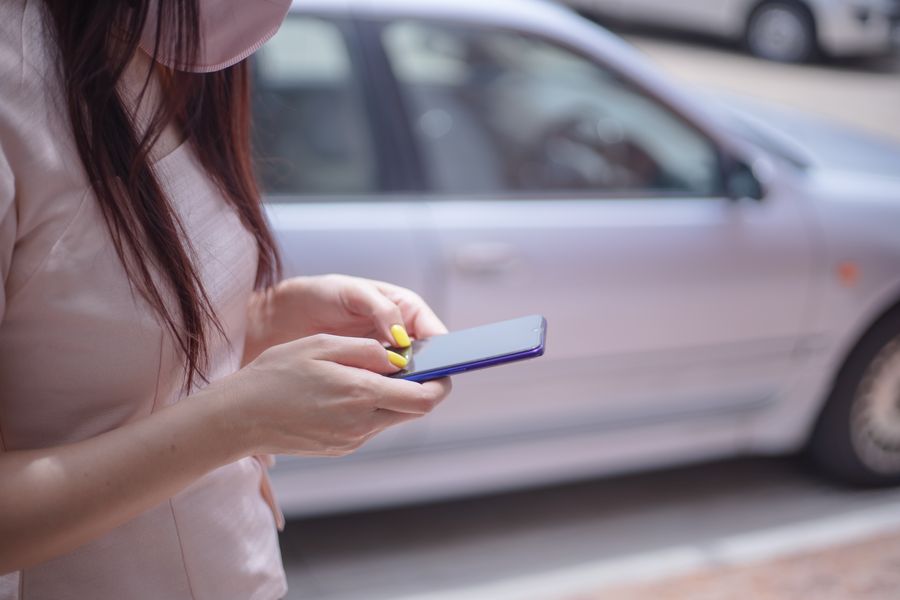 woman in pink blouse texting on a smartphone — Developers · Czechia: SDKs, a CLI, and an MCP server — the developer surface, complete.