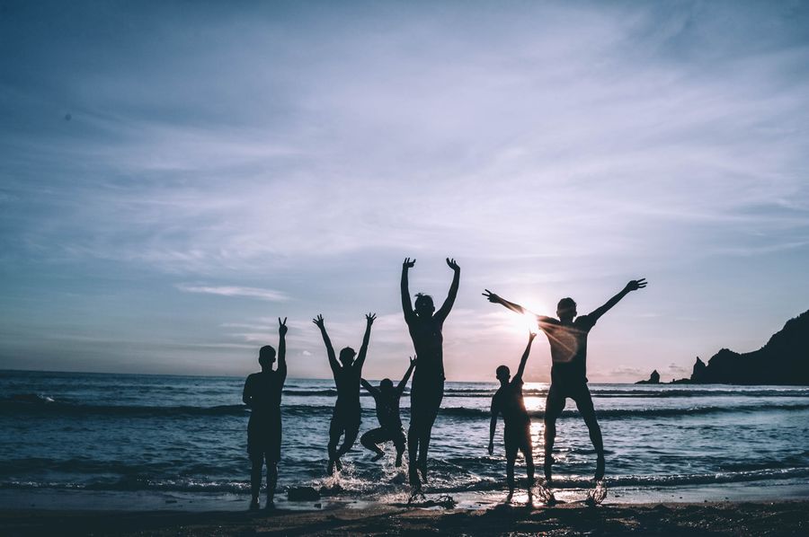 silhouette of people by the seashore — Developers · Papua New Guinea: The rental desk handshake: confirmation email open, license photo ready.