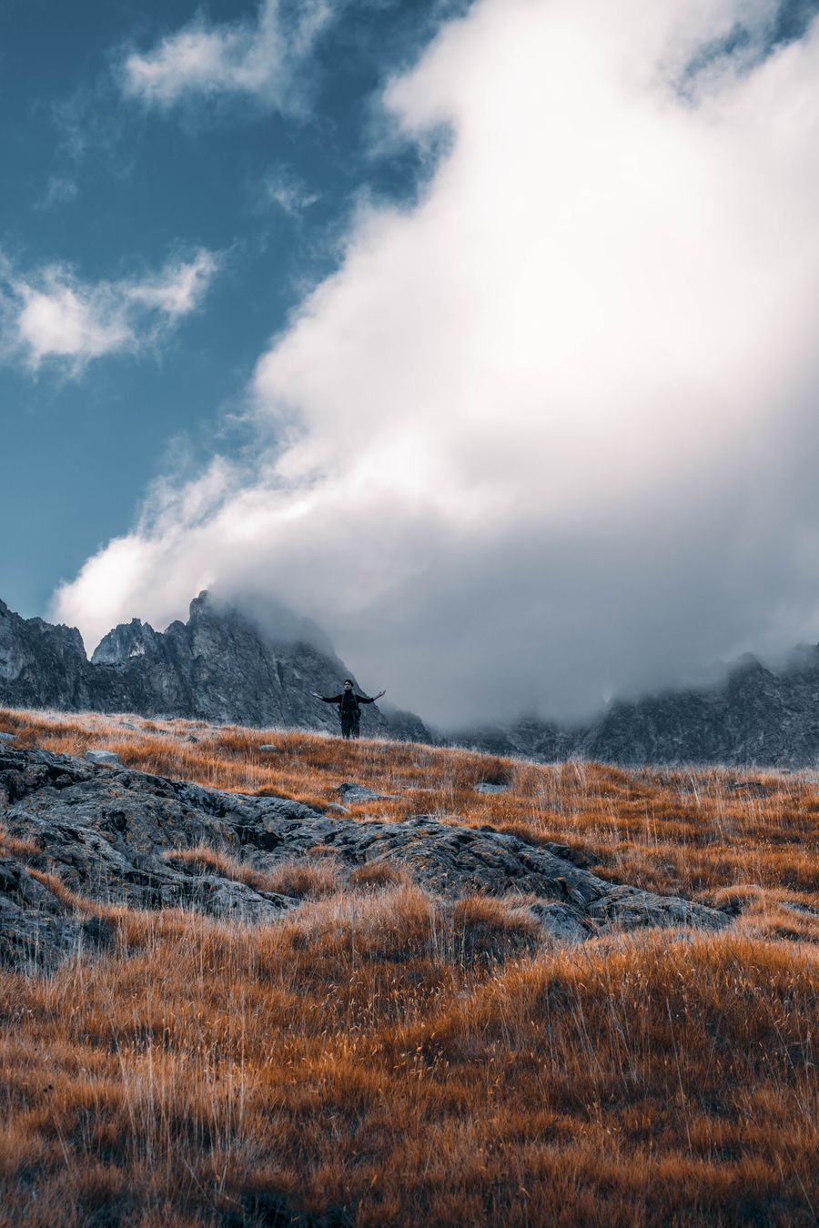 a person standing beside rocky mountain — Developers · the United Kingdom: Migrate from Twilio in three steps — the toolkit does the heavy lifting.