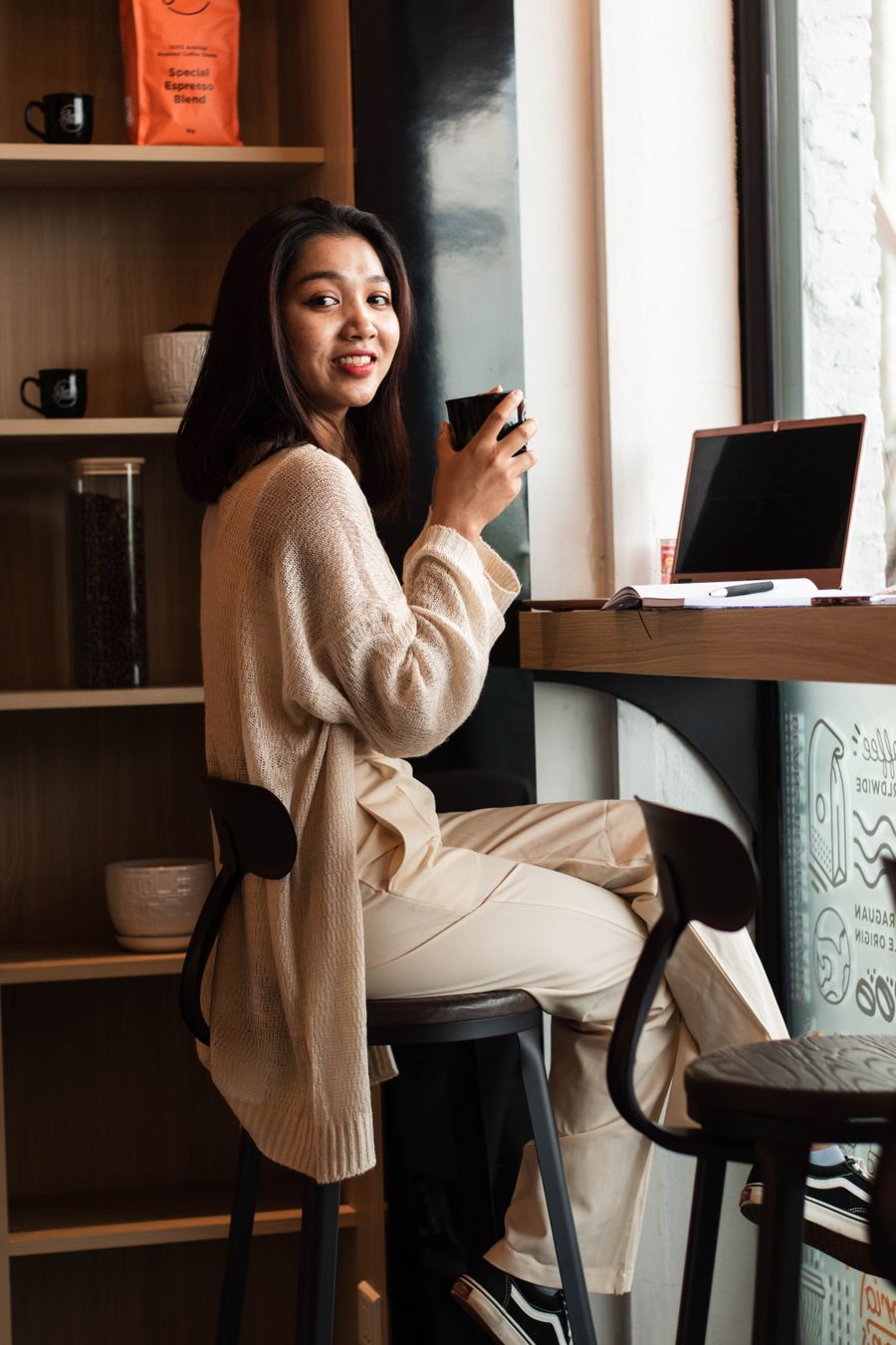 a woman holding a coffee