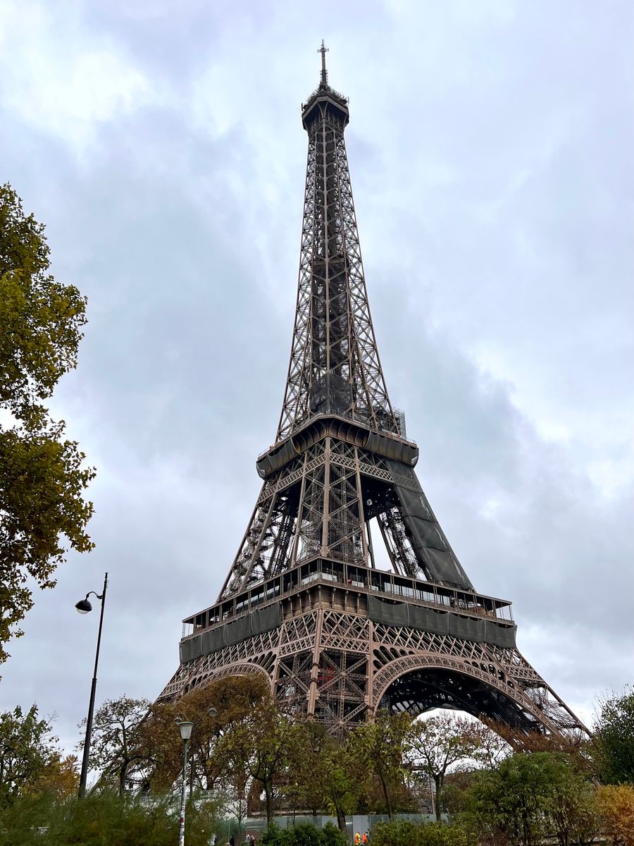low angle photo of eiffel tower under cloudy sky