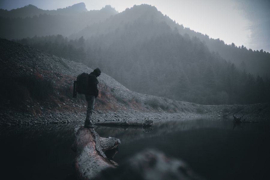 a man standing on wood log — Developers · Ecuador: The window seat office: emails sent somewhere over the ocean.