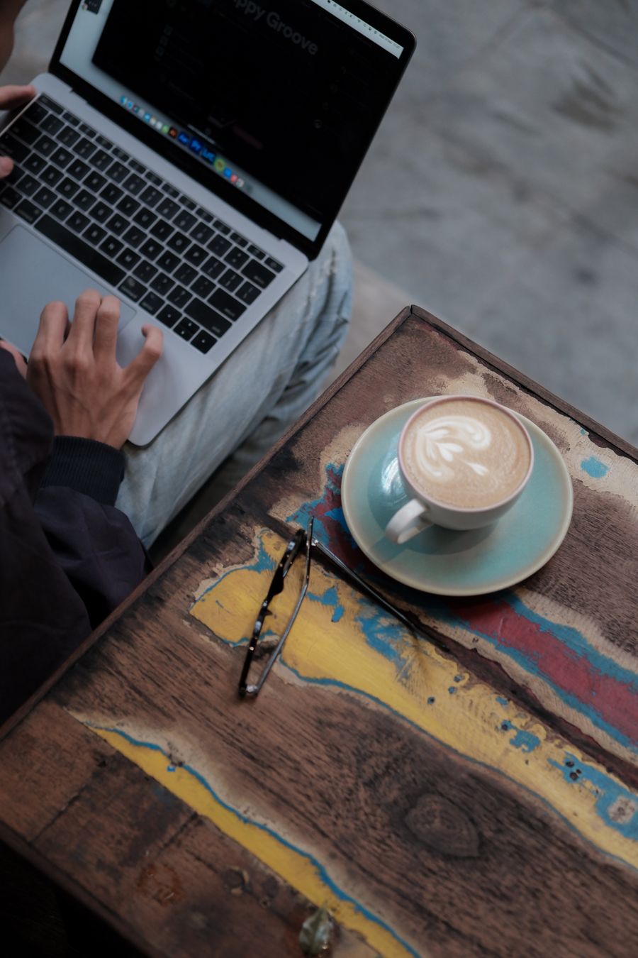 using a laptop and drinking coffee — Developers · Liechtenstein: The long layover: streaming, working and messaging, all covered.