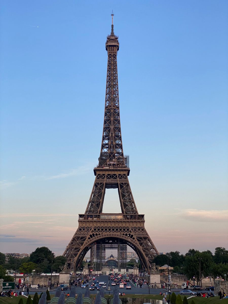 view of the eiffel tower at sunset paris france — Developers · North Macedonia: The rental desk handshake: confirmation email open, license photo ready.