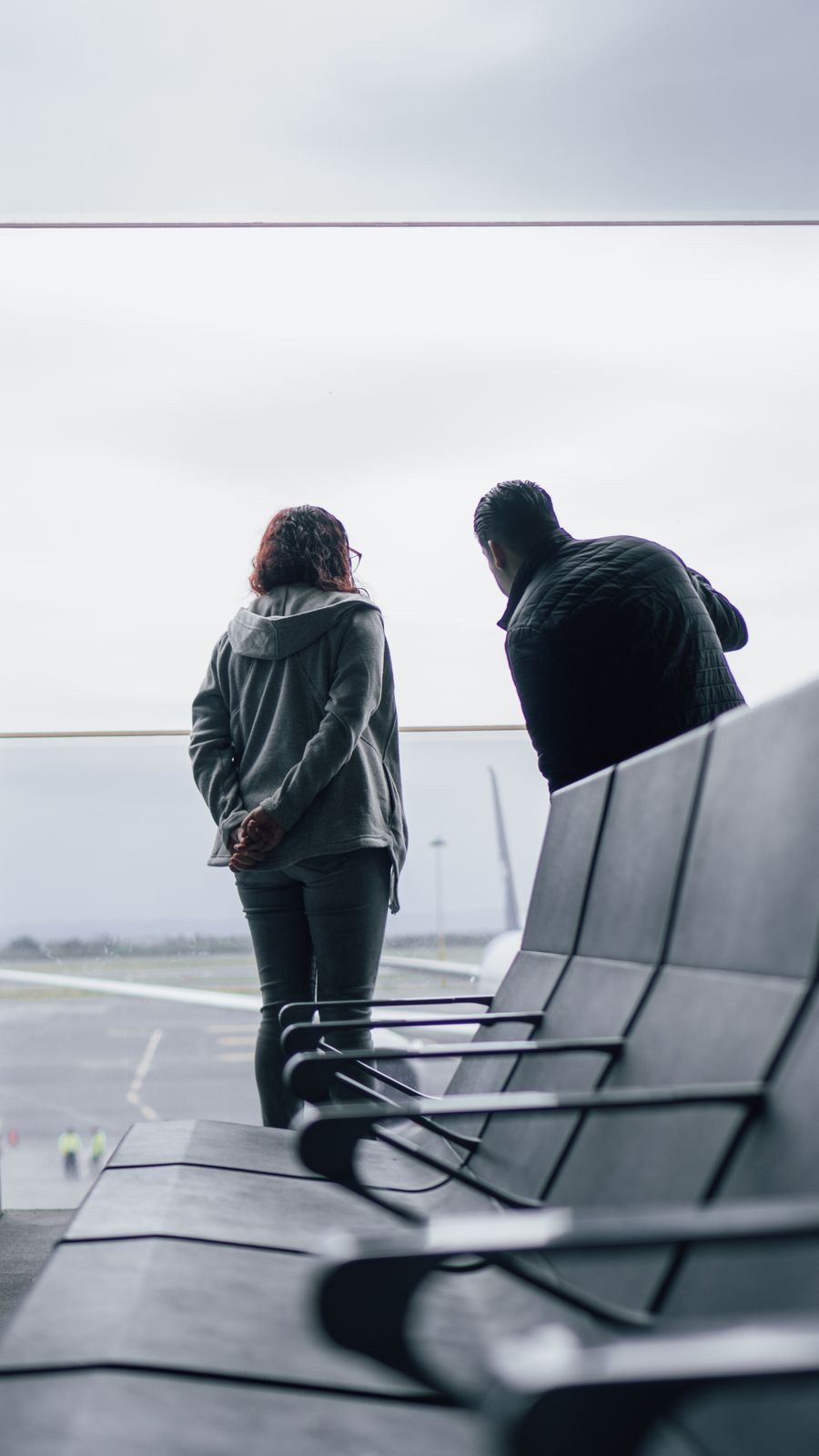 woman and man standing near windows on airport — Developers · Armenia: Golden hour, fully online — photo backups upload before dinner.