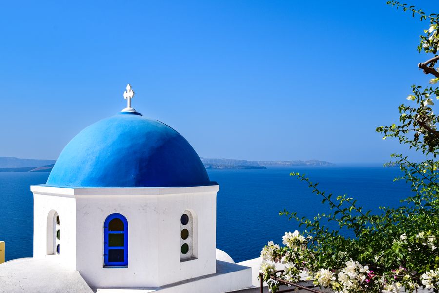dome of church on sea coast in greece — Developers · Thailand: Café office: hotspot running, video call stable, no hotel Wi-Fi roulette.