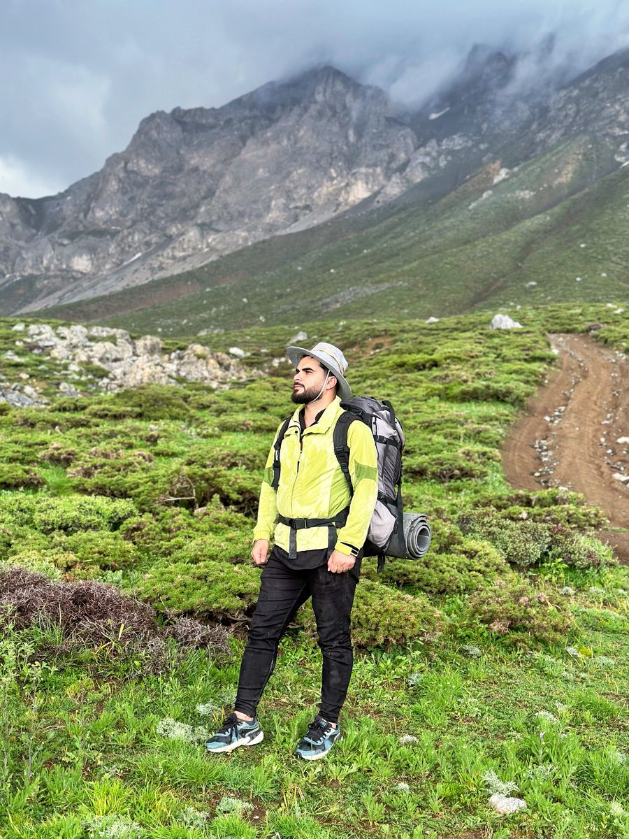 man wearing yellow jacket in a mountain valley — Developers · Canada: Build on the same rails the Canada checkout uses.