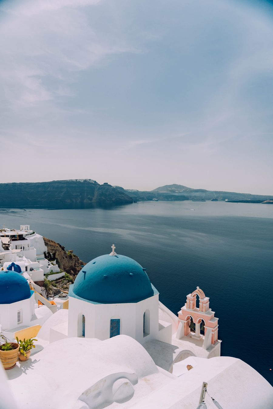 dome of a building on santorini greece — Developers · Armenia: The rental desk handshake: confirmation email open, license photo ready.