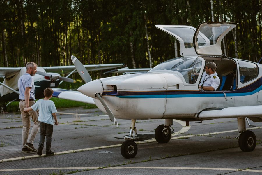 father with son walking near light aircraft — Developers · Thailand: Souvenir hunting with live currency conversion in your pocket.