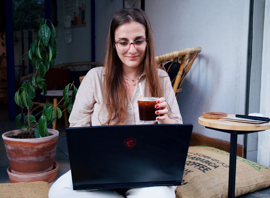 a woman sitting with a laptop — Developers · Haiti: Rain or shine, the connection holds — weather doesn't throttle data.