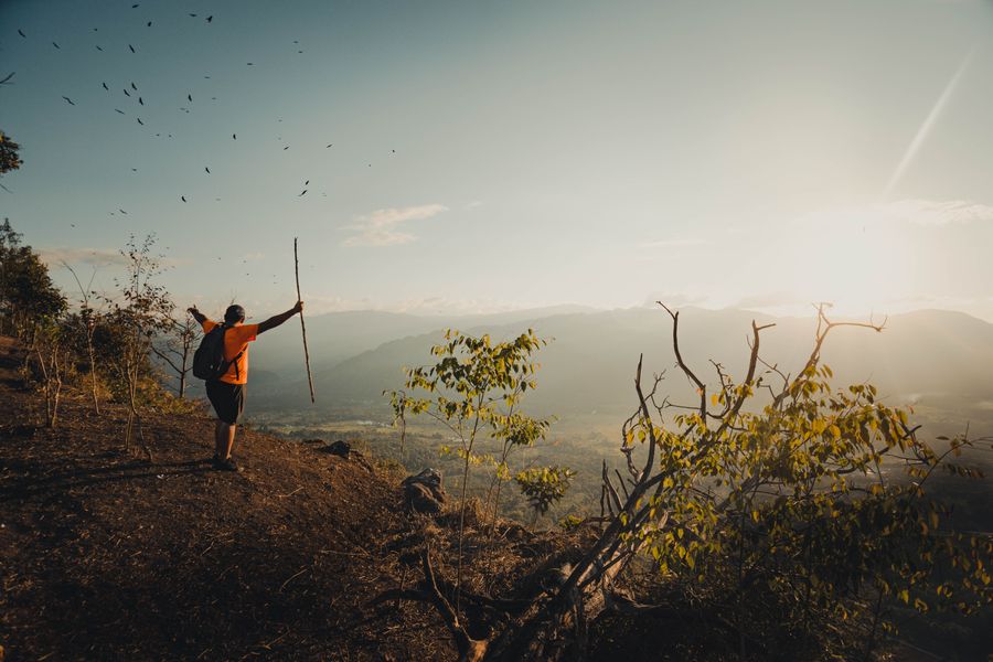 hiker expressing satisfaction after climbing a mountain — Docs: Family group chat: location shared, dinner plans settled in minutes.