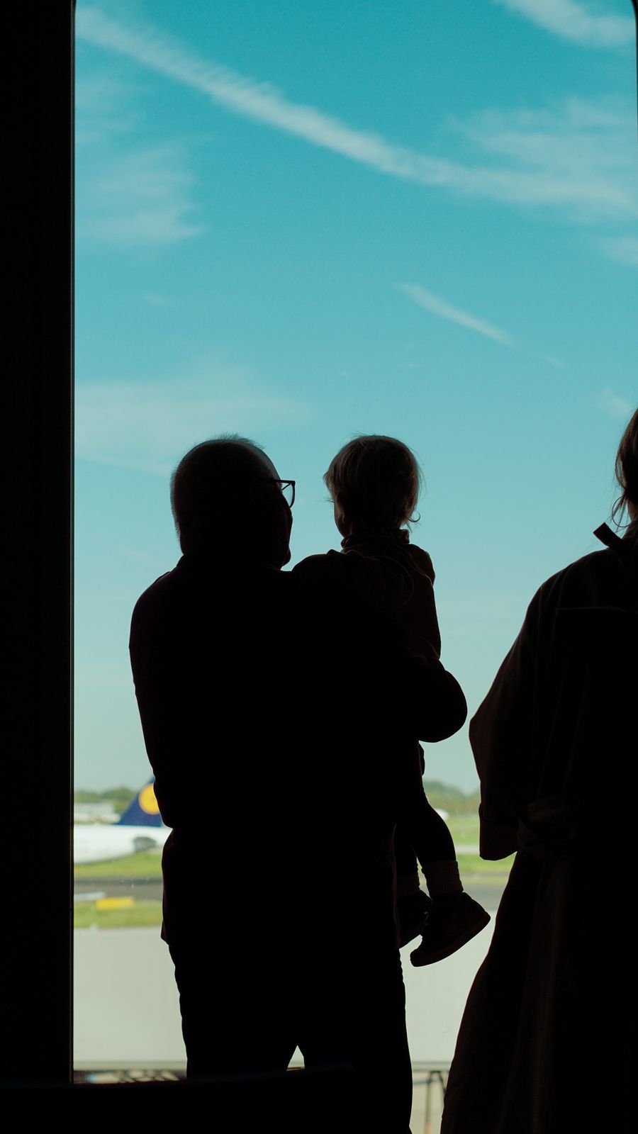a family is silhouetted against an airport window — Developers: SDKs, a CLI, and an MCP server — the developer surface, complete.