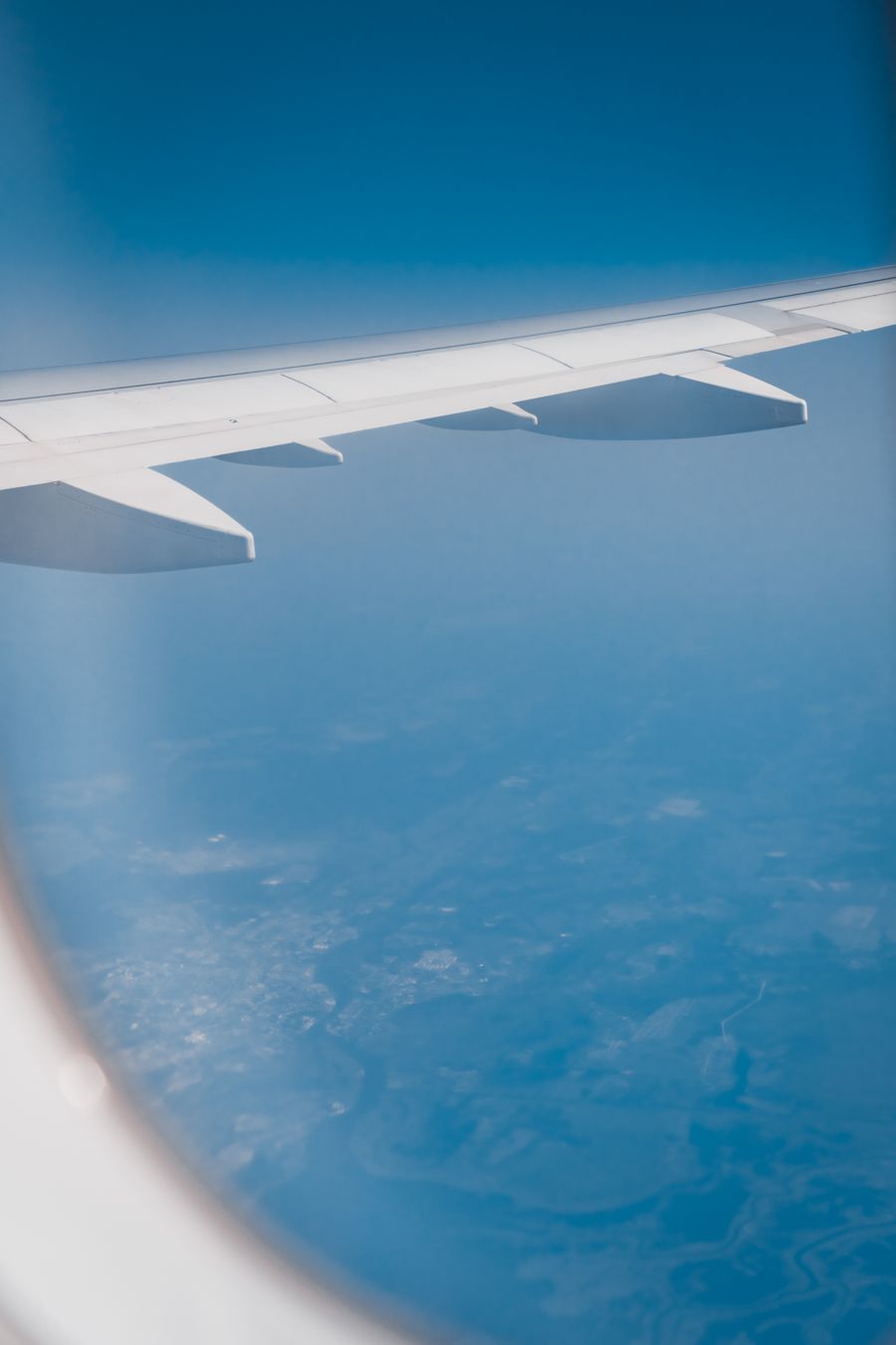 view from an airplane window — Developers · Malta: The red-eye recovery: hotel early-check-in arranged mid-flight.