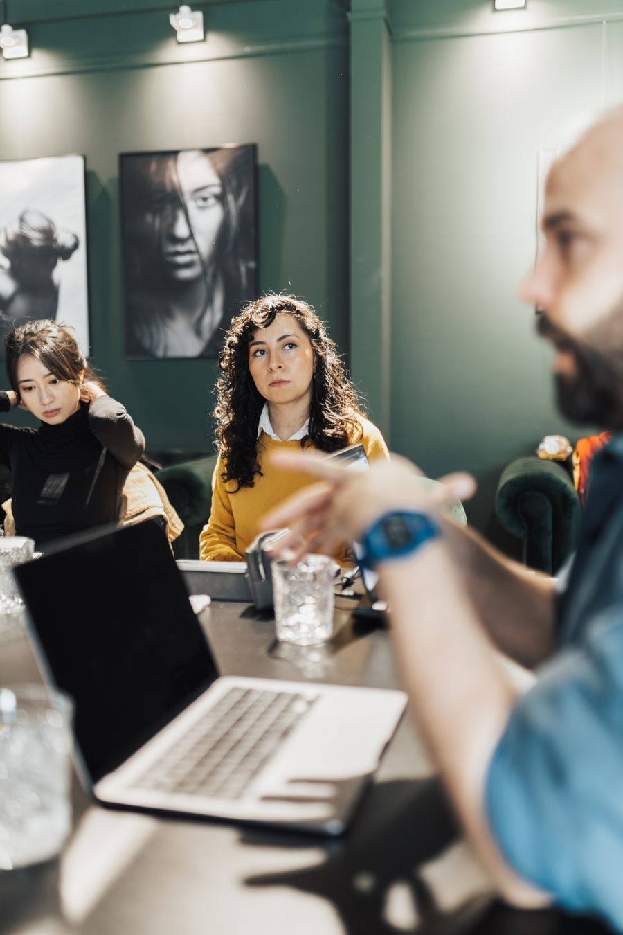 women and man sitting by table with laptop — Developers · Sudan: Migrate from Twilio in three steps — the toolkit does the heavy lifting.
