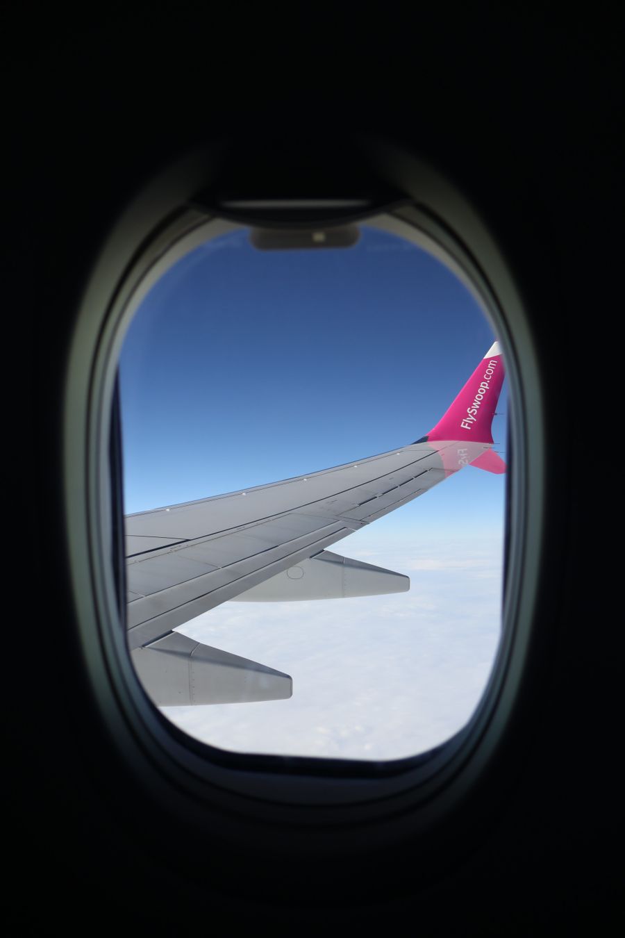 airplane wing seen through window — Developers · Kenya: Build on the same rails the Kenya checkout uses.