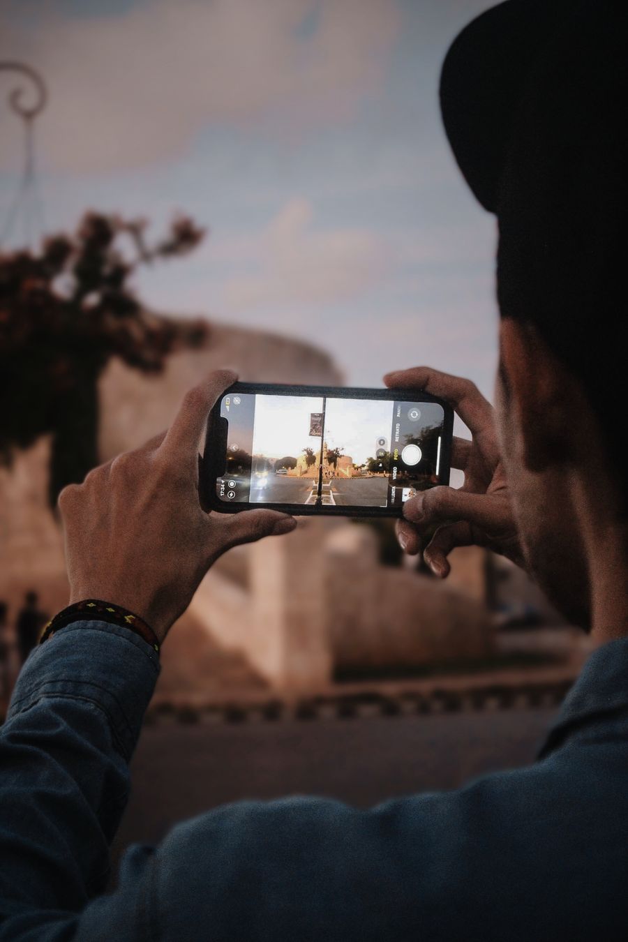 Man takes a photo of Mérida, Mexico with smartphone, capturing scenic view. — Developers · Croatia: One curl call provisions a Croatia eSIM — 200 OK in milliseconds.