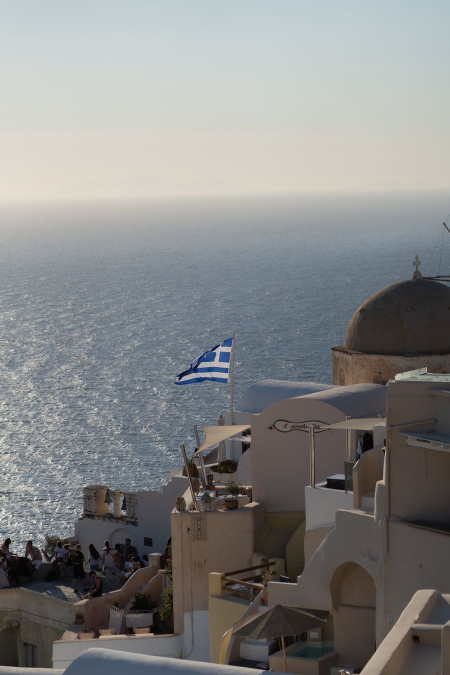 a view of a beach with a greek flag flying — Developers · Indonesia: Street level: navigation, rideshares and reviews, all instant.