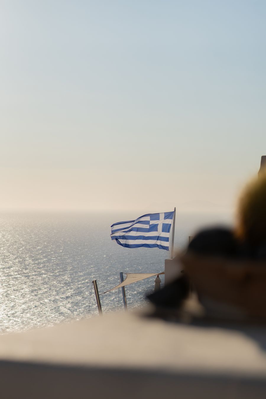 a greek flag is flying over the ocean — Developers · Mali: The long layover: streaming, working and messaging, all covered.