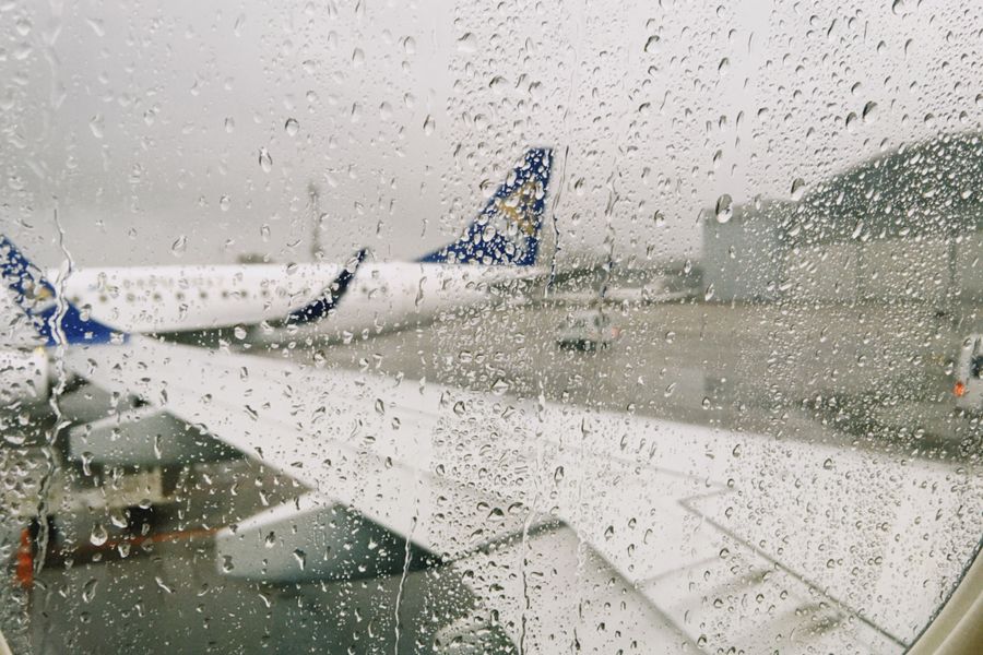 rainy airport view from airplane window — Developers · Mali: The API issues eSIMs the way your app issues everything else — over HTTPS.