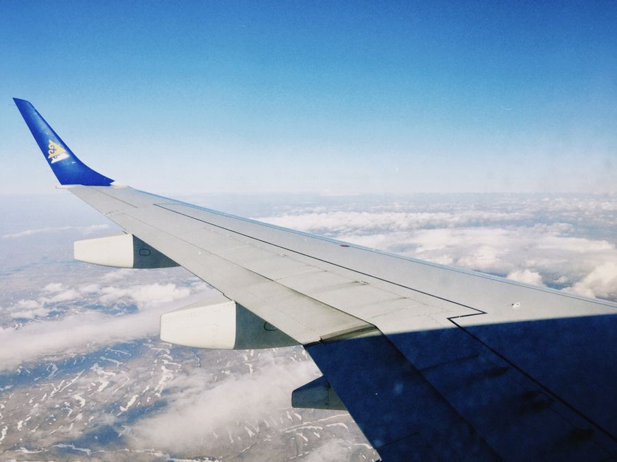 aerial view through airplane window over kazakhstan — Developers · the United Arab Emirates: The last night: photo album backed up, memories safe before wheels-up.