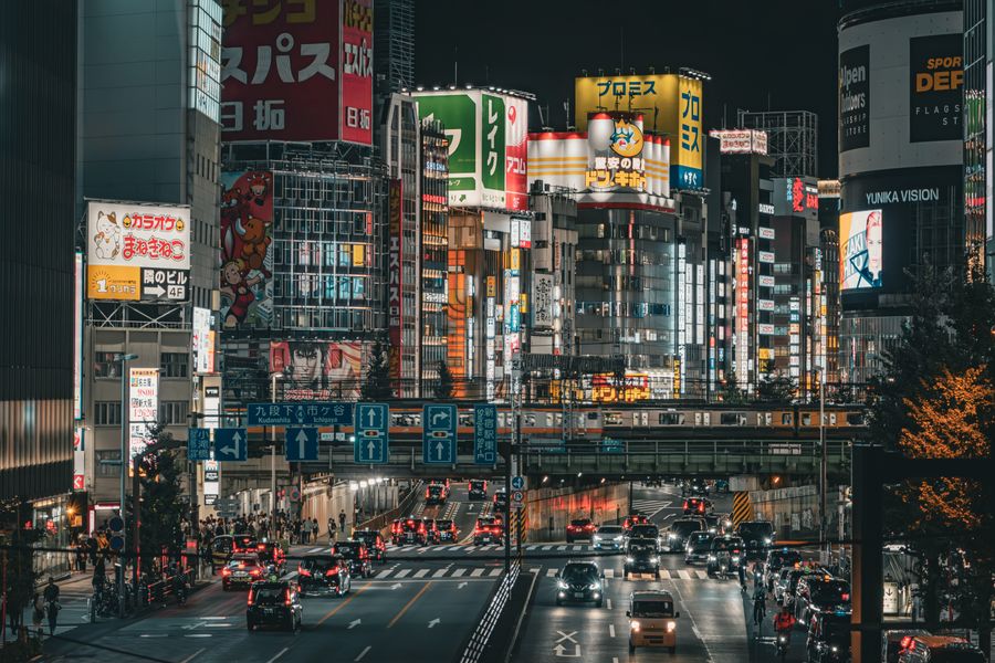 vibrant nightlife in shinjuku tokyo — Developers · Côte d'Ivoire: The rental desk handshake: confirmation email open, license photo ready.