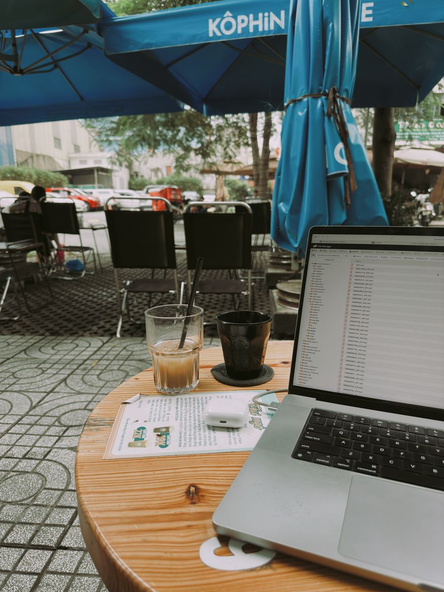 laptop and coffee at outdoor cafe workspace — Developers · the United Kingdom: API keys rotate in one click — the dashboard makes it boring.