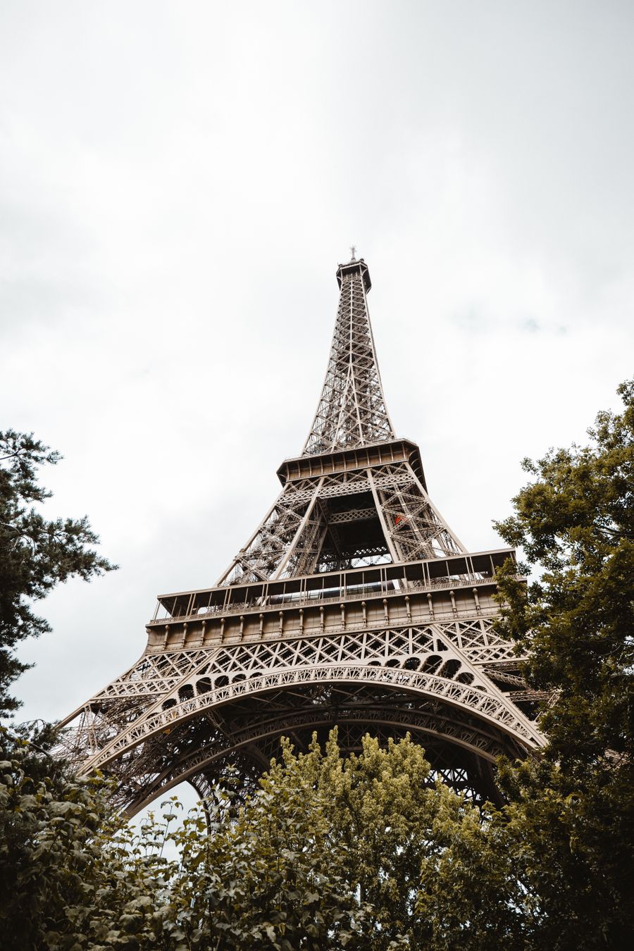 eiffel tower in paris framed by lush greenery — Developers · DR Congo: The window seat office: emails sent somewhere over the ocean.