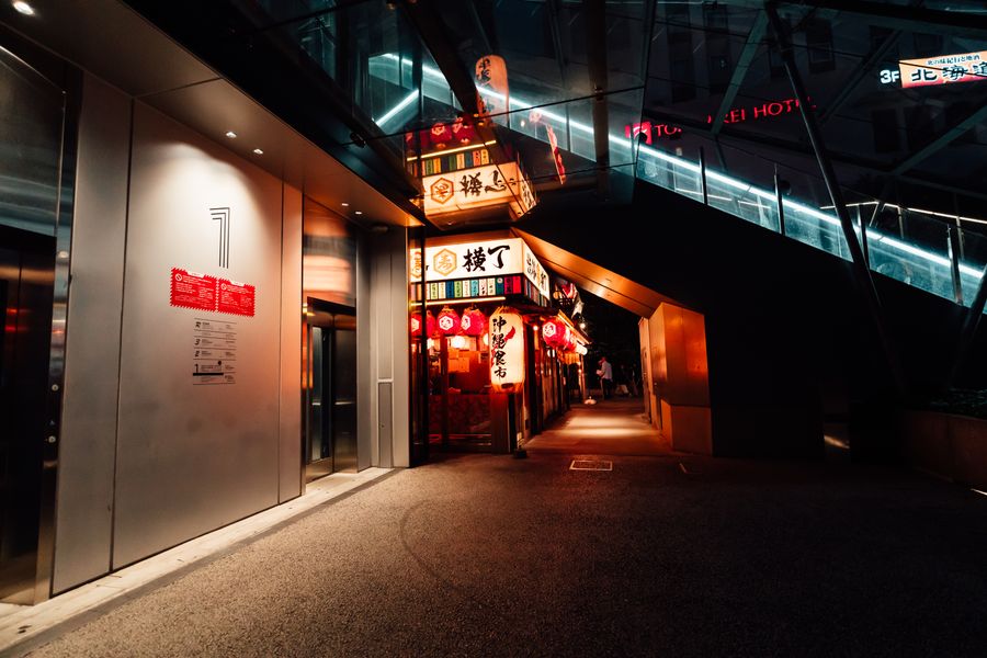 vibrant nightlife alleyway in japanese cityscape — Developers · Somalia: Street-food stalls and mobile pay: dinner ordered without a word of the language.