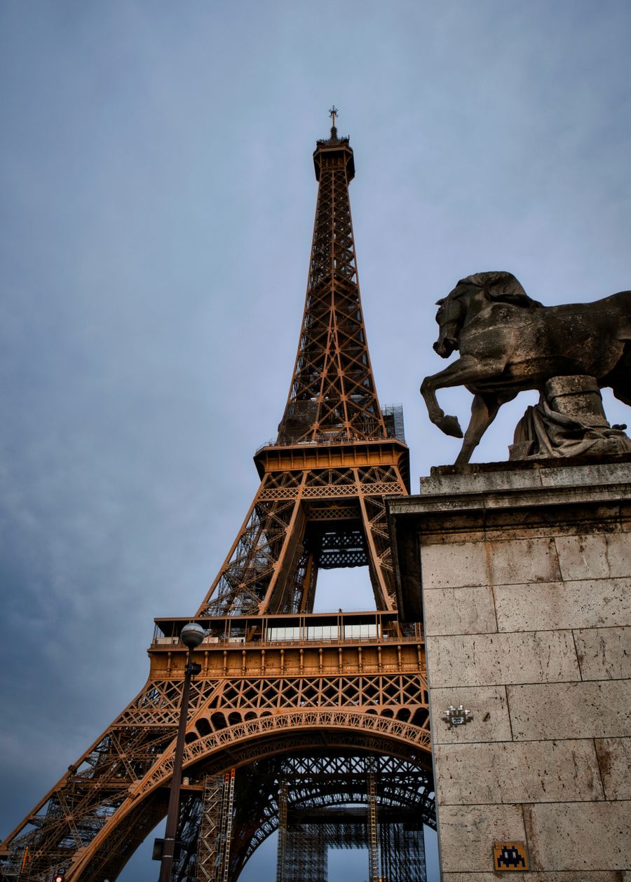 eiffel tower and statue in paris at dusk — Developers · the Philippines: City lights after dark — the eSIM doesn't care what time it is.