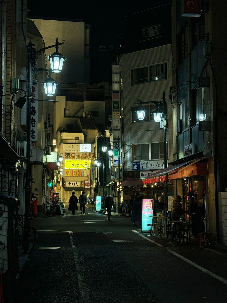 vibrant tokyo street at night with neon lights — Developers · Burkina Faso: The conference badge: QR ticket scanned, session schedule synced.