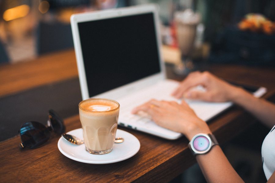 midsection of man using mobile phone while sitting on table — Developers · Mali: Café office: hotspot running, video call stable, no hotel Wi-Fi roulette.