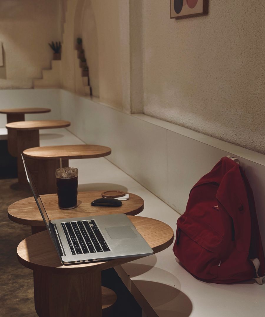 cozy cafe workspace with laptop and drink — Terms: The welcome home: eSIM deleted in one tap, no contract to cancel.