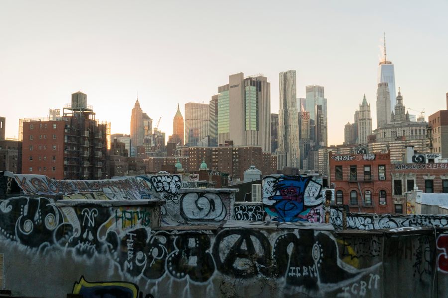 graffiti laden rooftop overlooking new york skyline — Developers · the Dominican Republic: Downtown, connected: the eSIM finds the fastest local network on its own.