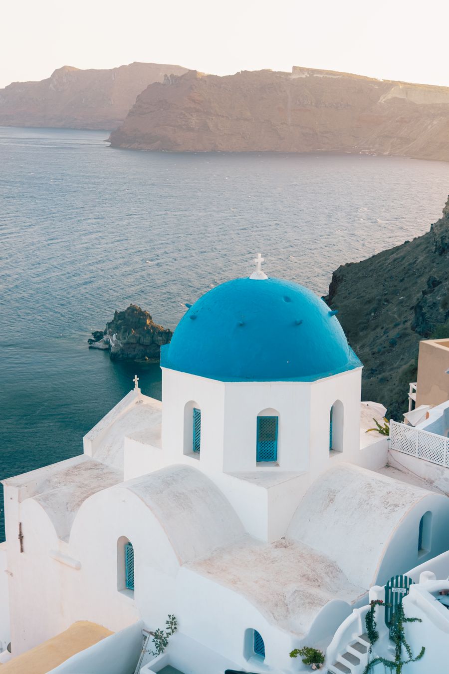 iconic blue dome church overlooking santorini coastline — Developers · Qatar: Rainy-day backup plan: indoor attractions researched from the hostel bunk.