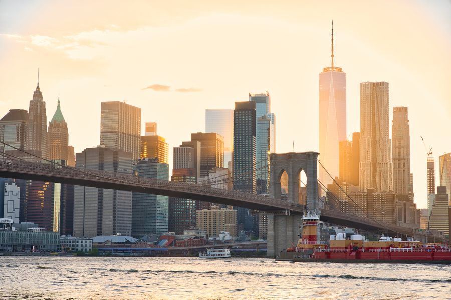 sunset over brooklyn bridge and nyc skyline