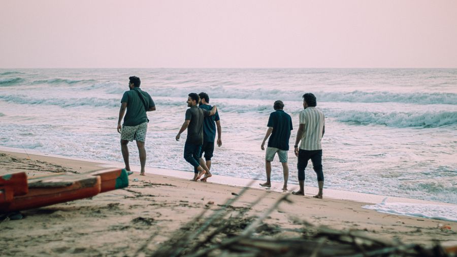 group of friends walking along beach — Developers · Ethiopia: The commute, handled: podcasts downloaded, messages sent, no dead zones.