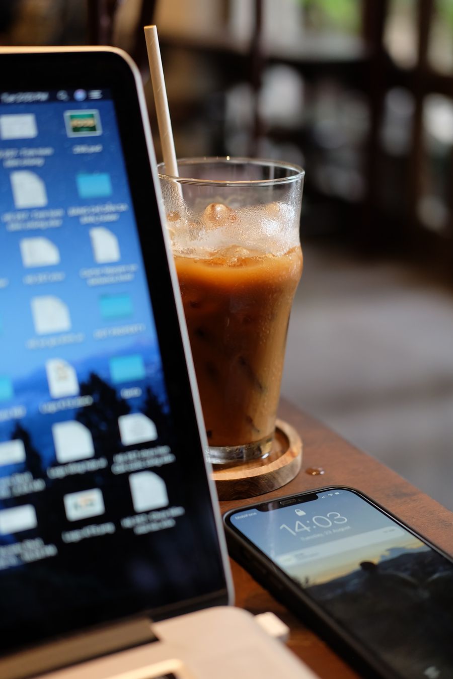 coffee shop workspace with laptop and iced coffee — Developers · Ecuador: Sandbox first: test provisioning without spending a cent.
