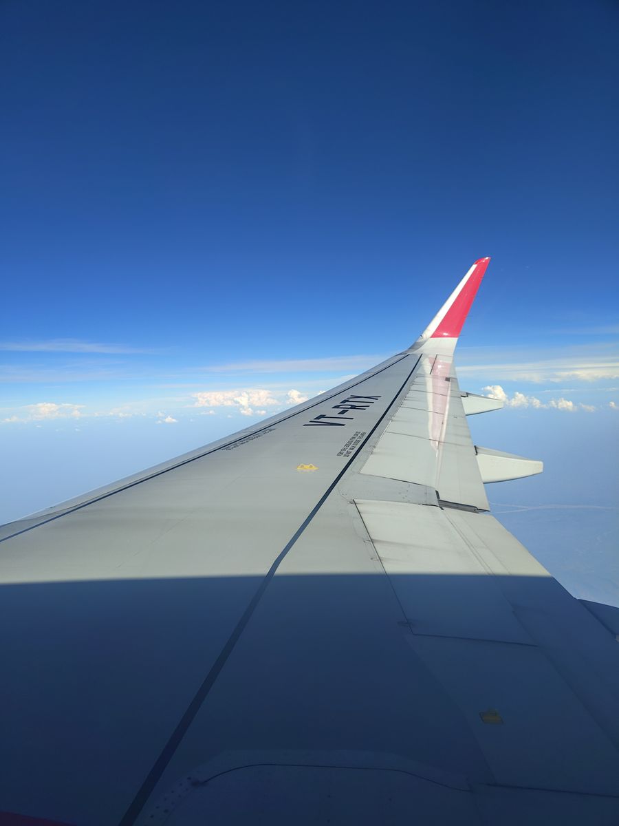 airplane wing view against clear blue sky — Developers · Burkina Faso: Street-food stalls and mobile pay: dinner ordered without a word of the language.
