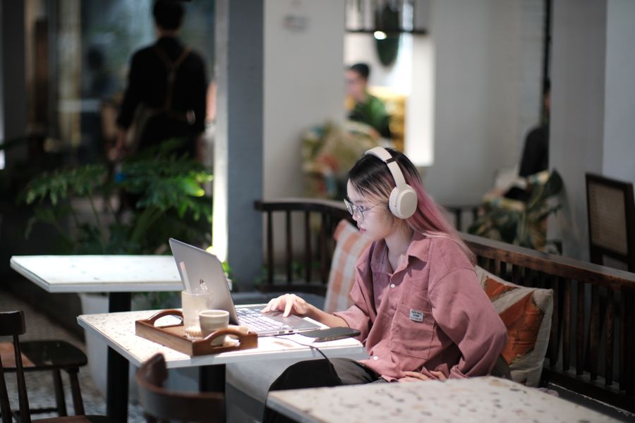 young woman studying in vietnamese cafe — Developers · Morocco: Lost in the medina, found by GPS: the blue dot never lies.