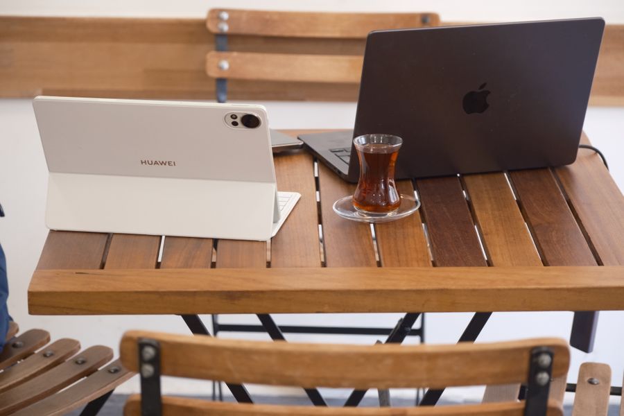 modern workspace with laptop and tea in izmir cafe — Developers · Luxembourg: Duty-free browsing: price-checked against home before buying.