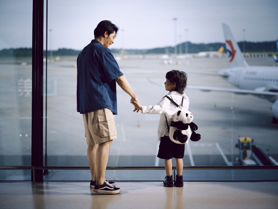 father and child holding hands at airport window — Developers · Bangladesh: Build on the same rails the Bangladesh checkout uses.
